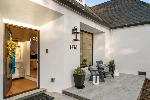 a living room with fireplace furniture and a chandelier