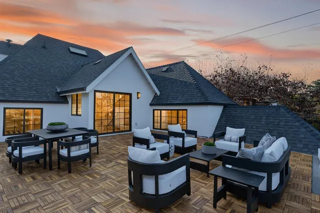 a bedroom with a bed and a dresser next to a window