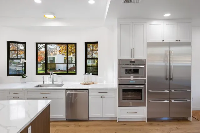 a bathroom with a granite countertop sink a toilet and a mirror