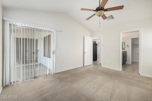 a view of empty room with ceiling fan