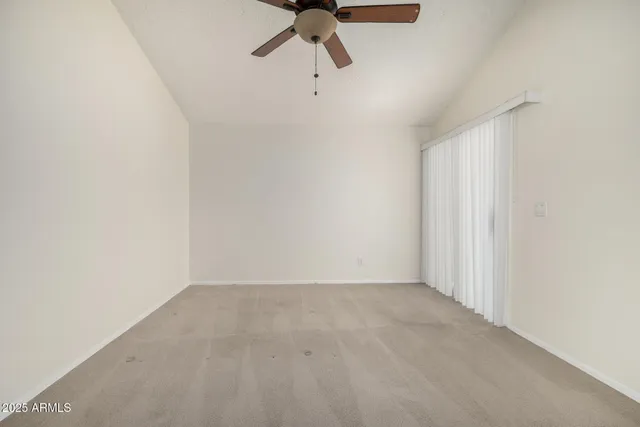 a view of a room with a ceiling fan