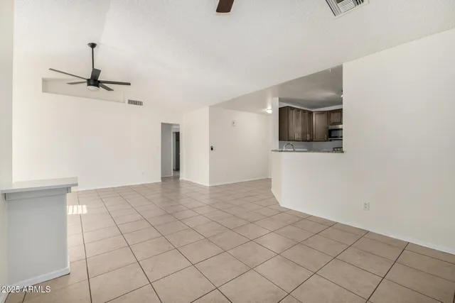 a view of a livingroom with an empty space and a workspace
