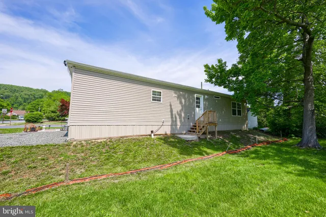 a view of a backyard with plants and a patio