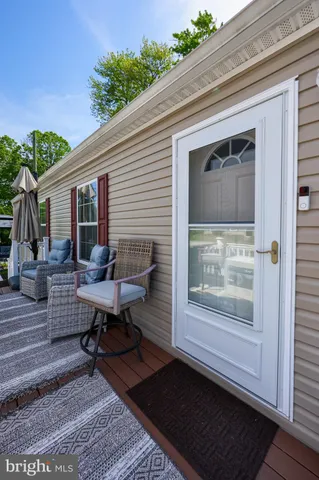 a view of a deck with table and chairs with wooden floor and fence