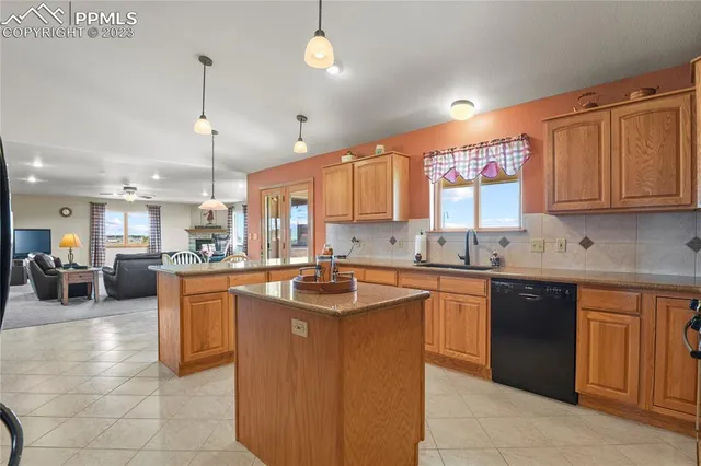 a kitchen with stainless steel appliances granite countertop a sink a stove and a refrigerator