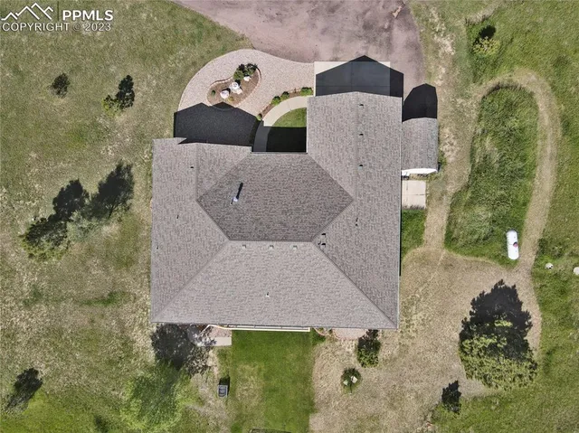 an aerial view of a house with yard