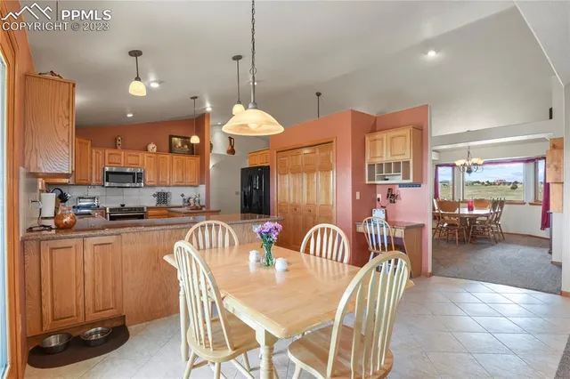 a kitchen with stainless steel appliances granite countertop a sink a stove and a refrigerator