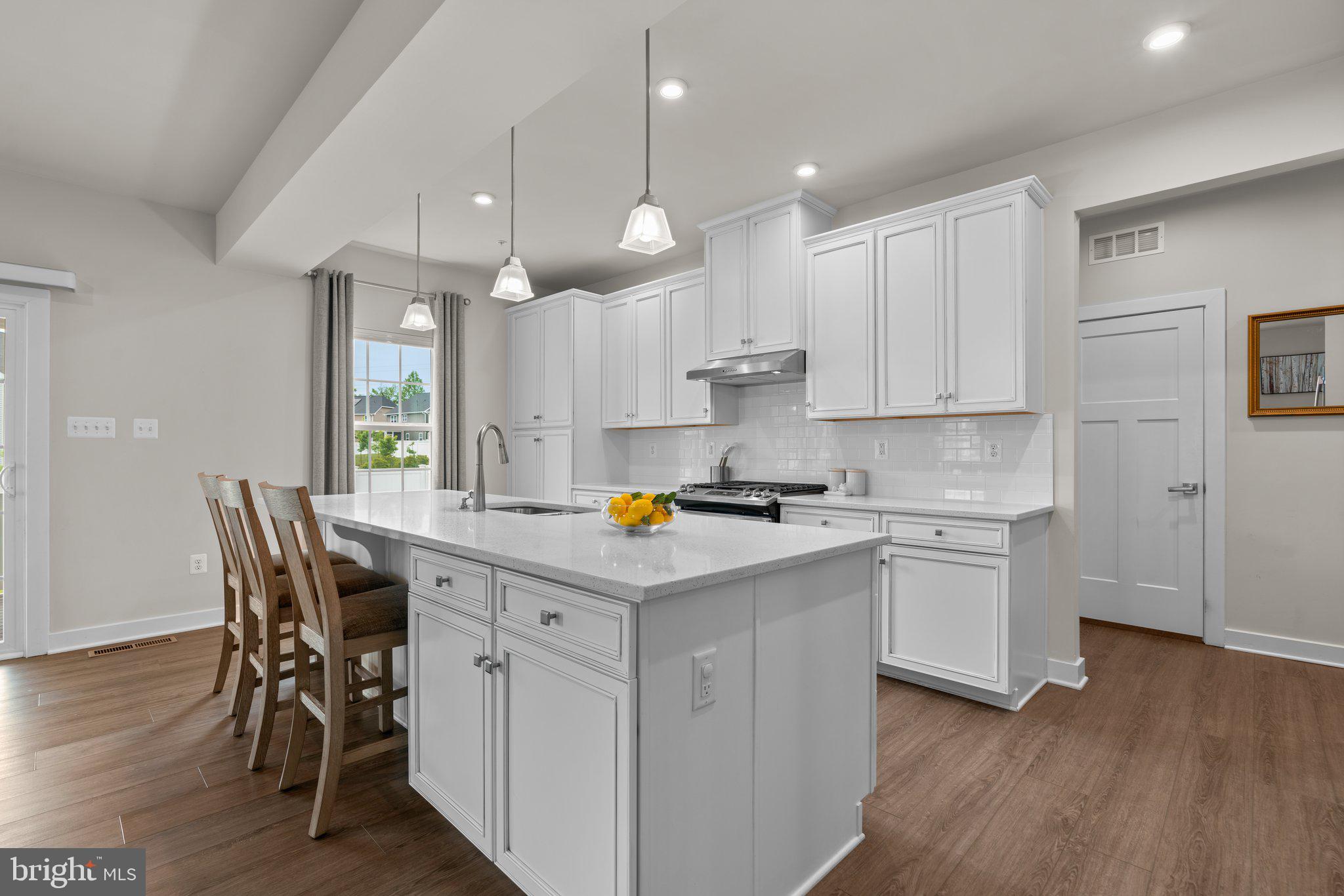 3150 Dodder Way Odenton, MD 21113 - Photo 12 of 83 a kitchen with kitchen island granite countertop a sink a center island and cabinets