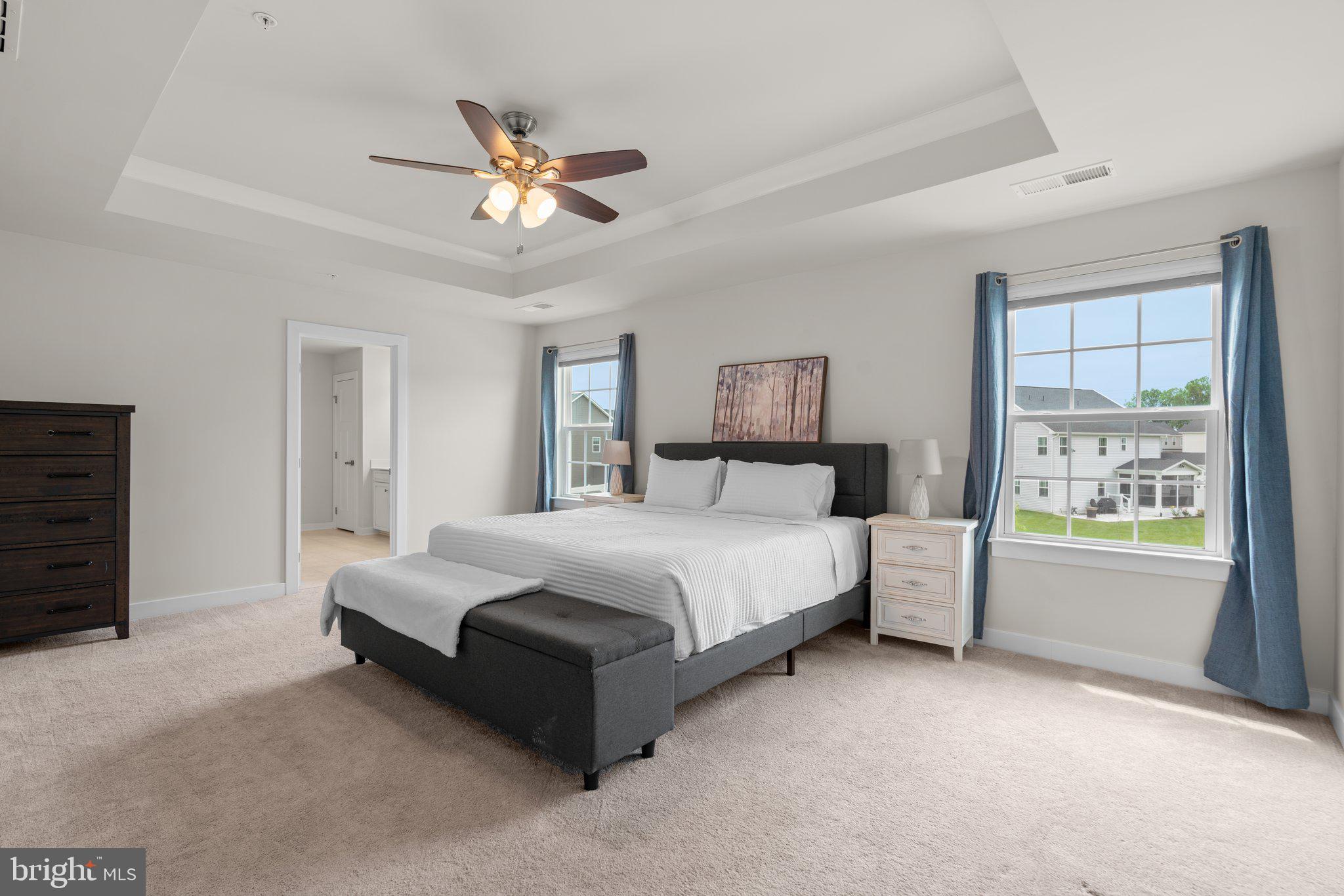 3150 Dodder Way Odenton, MD 21113 - Photo 19 of 83 a spacious bedroom with a large bed and a chandelier fan