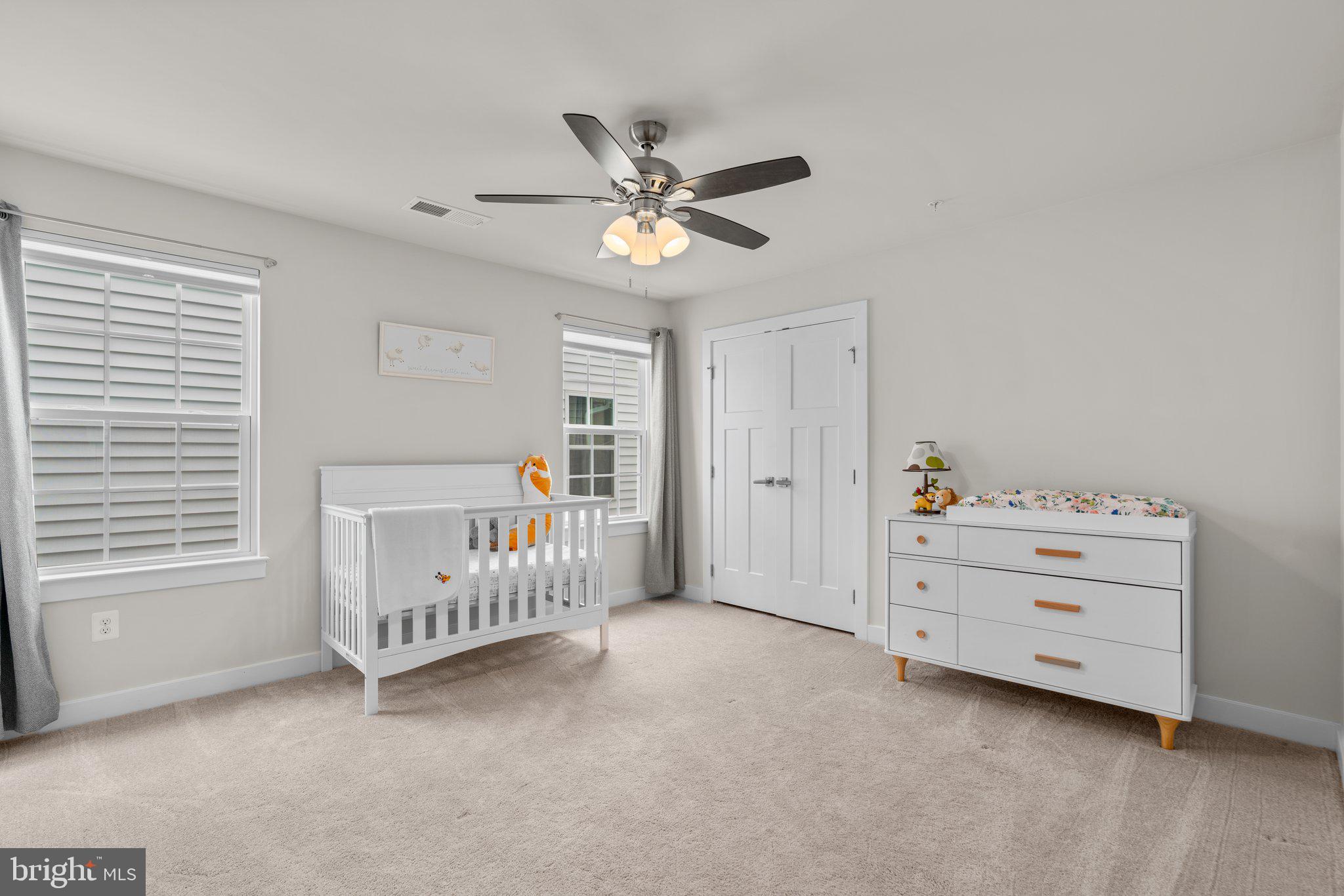 3150 Dodder Way Odenton, MD 21113 - Photo 32 of 83 a view of a bedroom with baby crib and a ceiling fan
