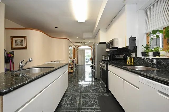 a kitchen with granite countertop a sink and cabinets