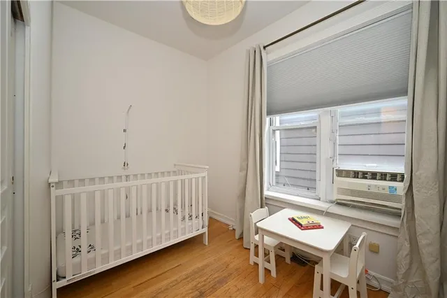 a view of a room with furniture and wooden floor
