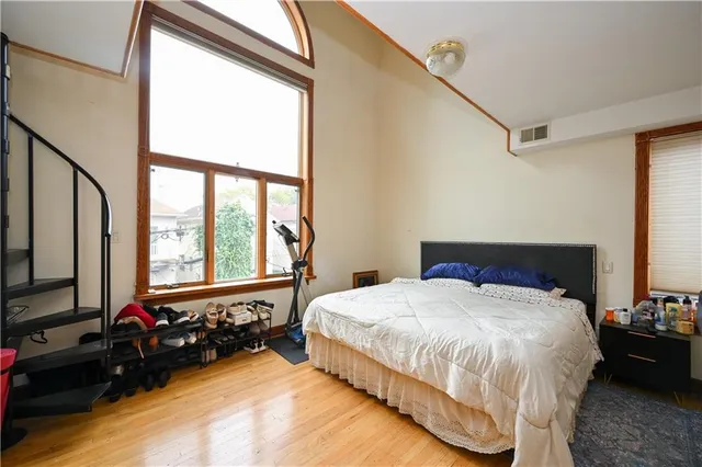 a bedroom with a bed and a large window