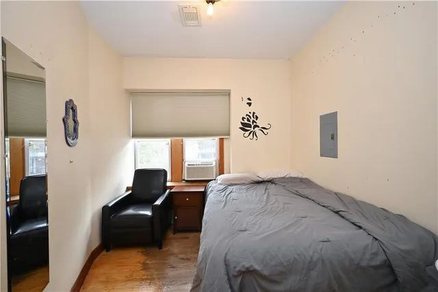 a bed sitting in a bedroom next to a window