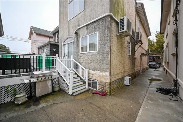 a view of a house with a wooden deck