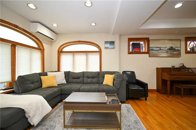 a living room with furniture and a piano