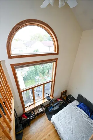 a bedroom with two beds and a large window