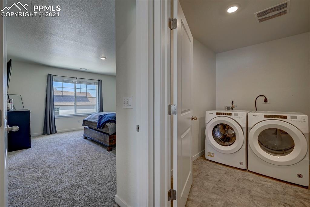 45780 Silverdrop Avenue Bennett, CO 80102 - Photo 21 of 43 a view of a storage & utility room with washer and dryer