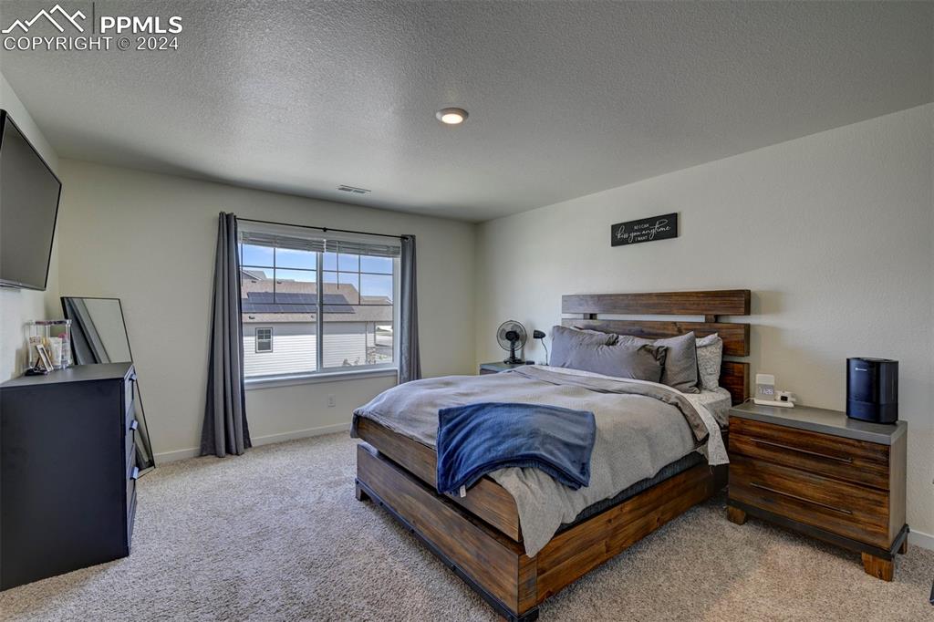 45780 Silverdrop Avenue Bennett, CO 80102 - Photo 22 of 43 a bedroom with a bed and a window