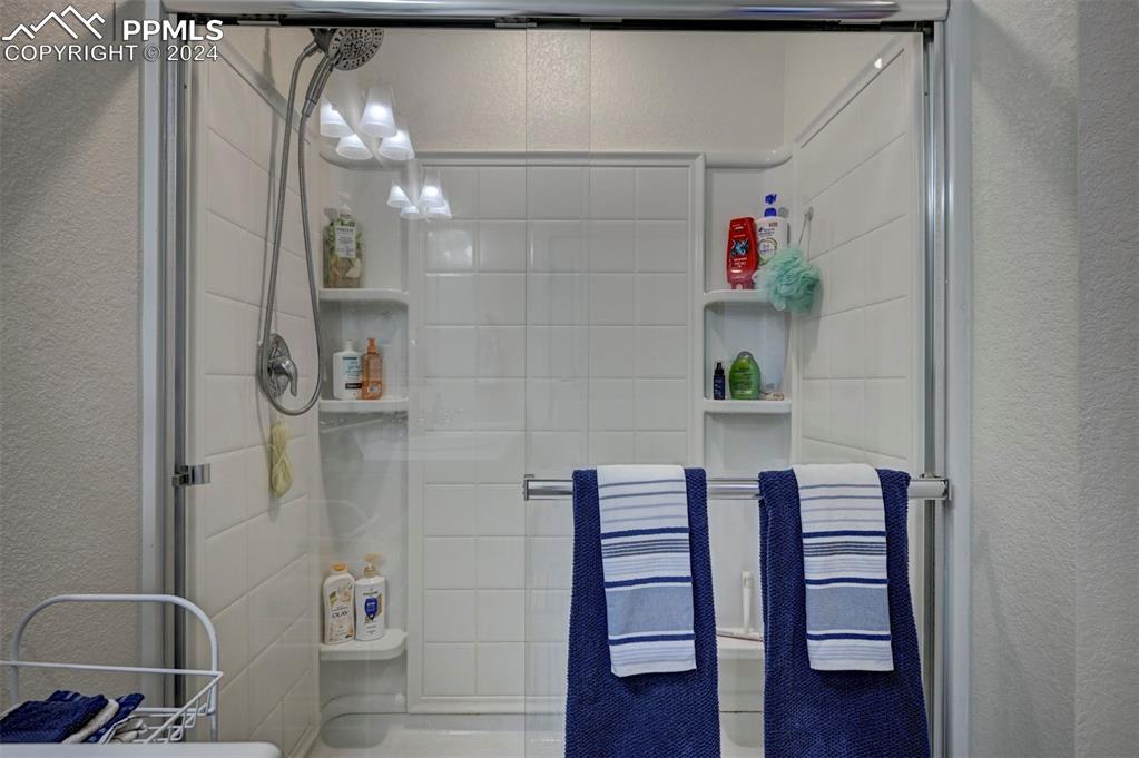 45780 Silverdrop Avenue Bennett, CO 80102 - Photo 27 of 43 a bathroom with a shower