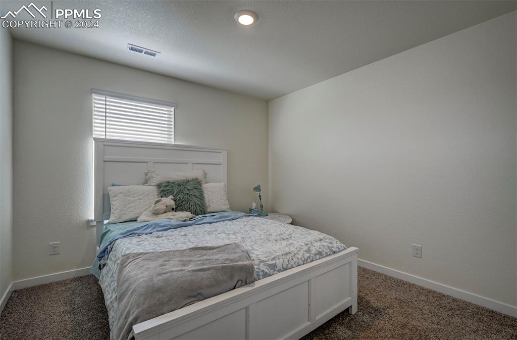 45780 Silverdrop Avenue Bennett, CO 80102 - Photo 31 of 43 a bedroom with a bed and a window