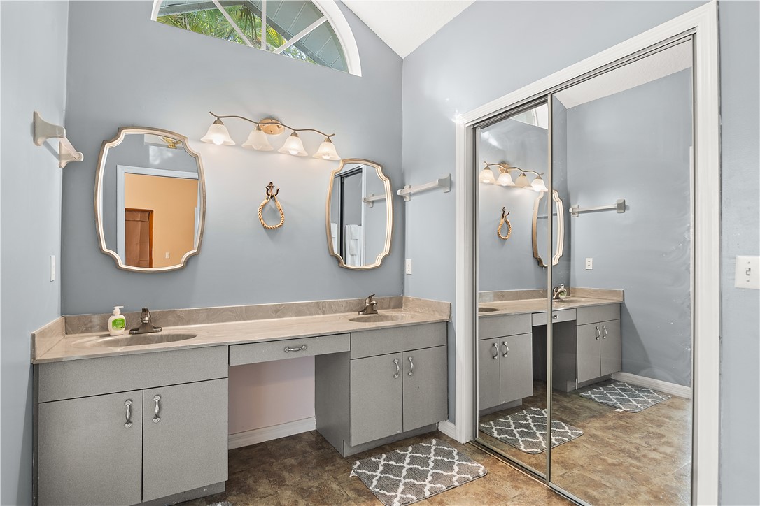 922 Jackson Way Fort Pierce, FL 34949 - Photo 20 of 34 a bathroom with a double vanity sink and a mirror