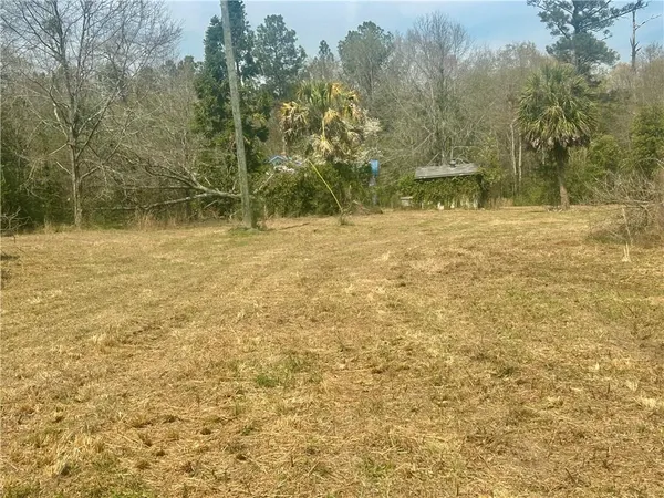 a view of a yard with wooden fence