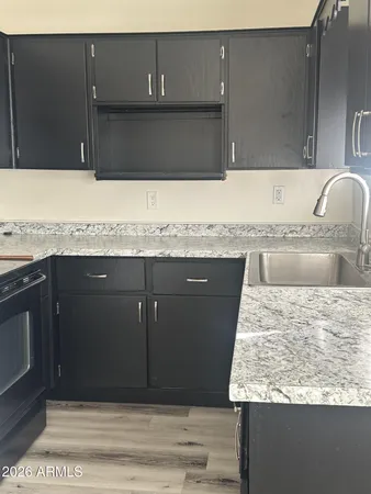 a view of kitchen with granite countertop cabinets