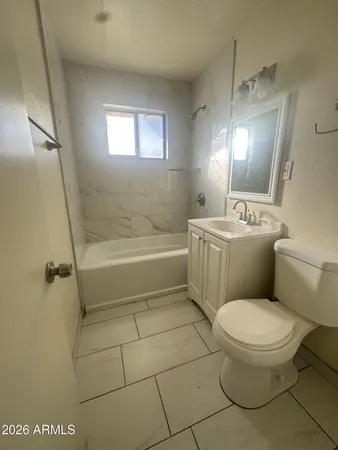 a bathroom with a toilet a sink and bathtub