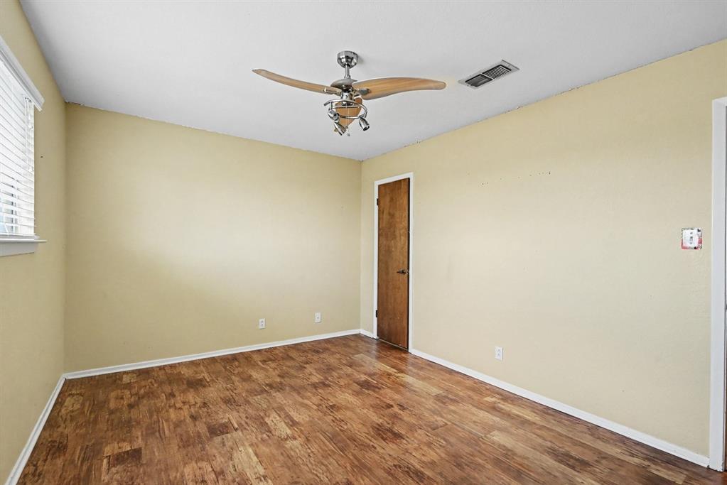 332 Cook Road Willow Park, TX 76087 - Photo 20 of 26 Wood-finish flooring, ceiling fan with integrated lighting, and window with horizontal blinds