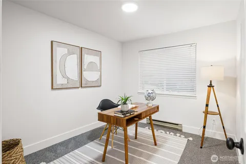 a workspace room with furniture and a window