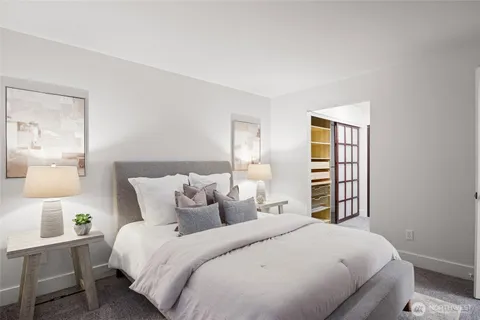 a bedroom with a bed and a night stand