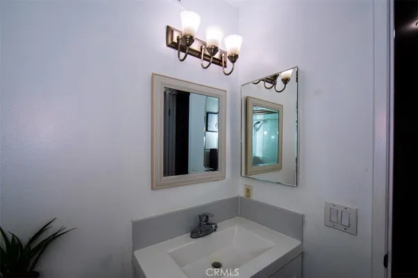 a white toilet sitting next to a bathroom sink