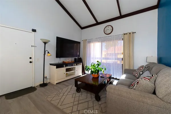 a living room with furniture a window and a flat screen tv