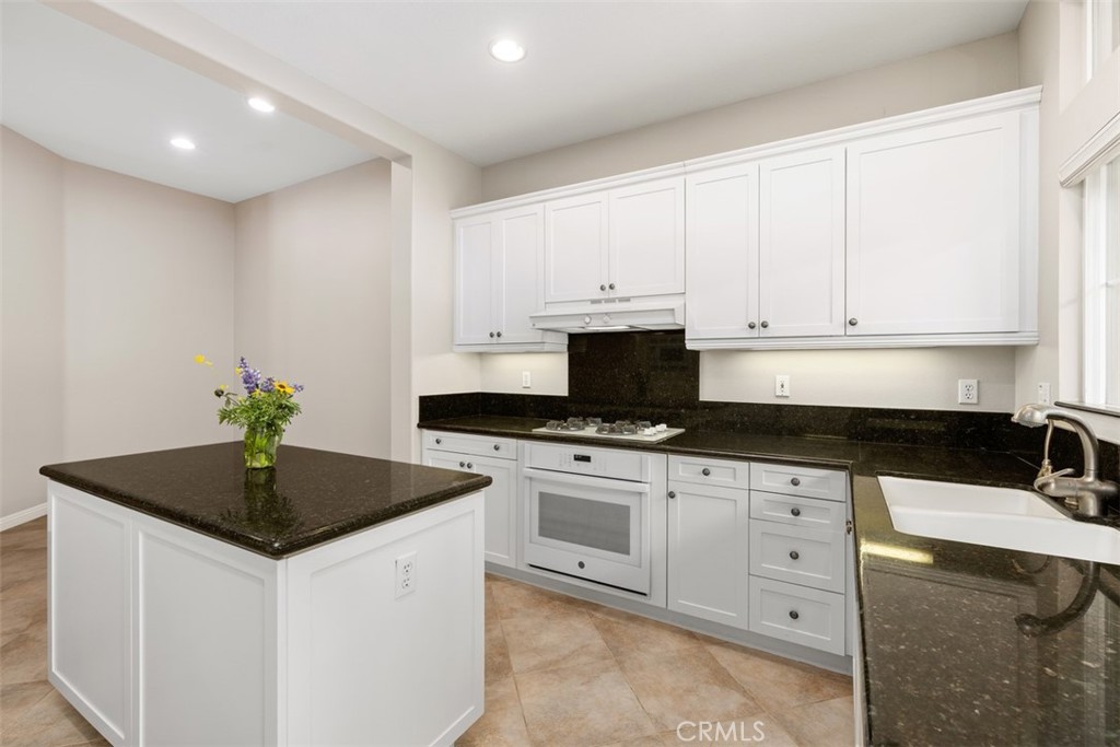 61 Burlingame Irvine, CA 92602 - Photo 8 of 13 a kitchen with granite countertop a sink a stove and cabinets
