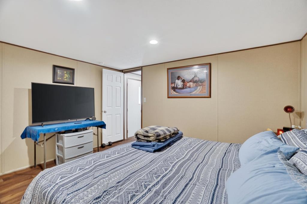 9705 Nolan Rnch Loop Godley, TX 76044 - Photo 20 of 40 a bedroom with a bed and a flat screen tv