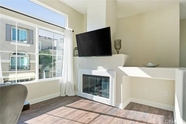 a living room with a flat screen tv and a fireplace