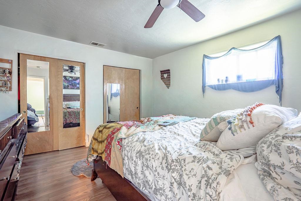 470 Riverside Avenue Chester, CA 96020 - Photo 18 of 25 a bedroom with a large bed and a wooden floor