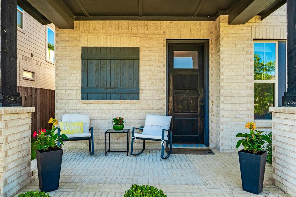 9341 Loggerhead Way Fort Worth, TX 76118 - Photo 6 of 35 Inviting front porch featuring light-colored brick exterior, dark wood-finish entry door with glass paneling, and a brick paver patio