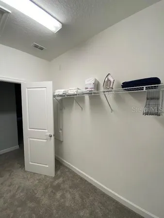 a room with a table chair and wooden floor