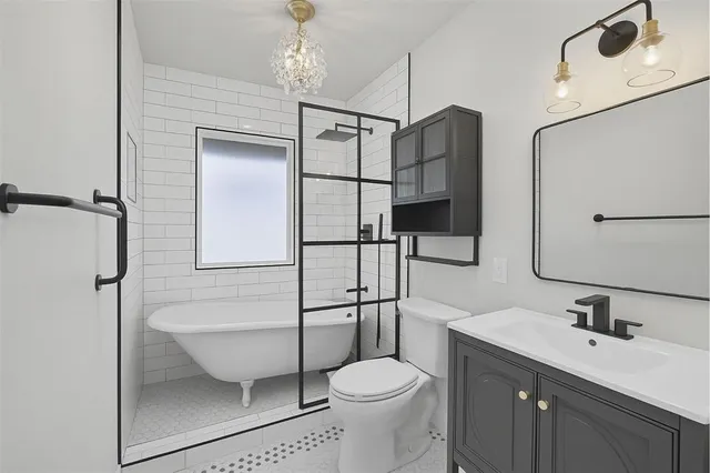 a bathroom with a toilet sink and shower