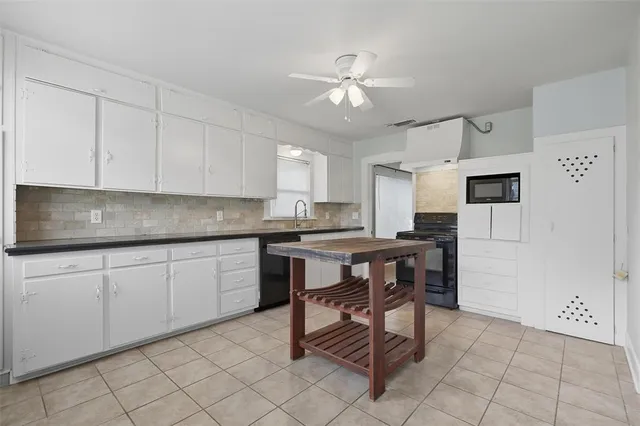 a kitchen with cabinets appliances and a center island