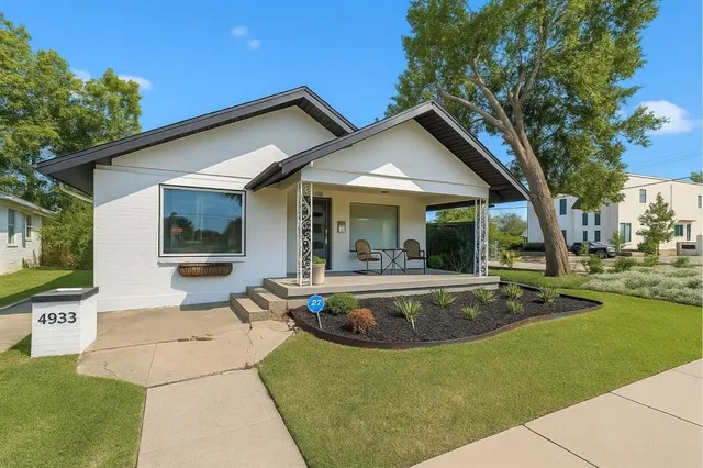 a view of house with swimming pool and outdoor seating