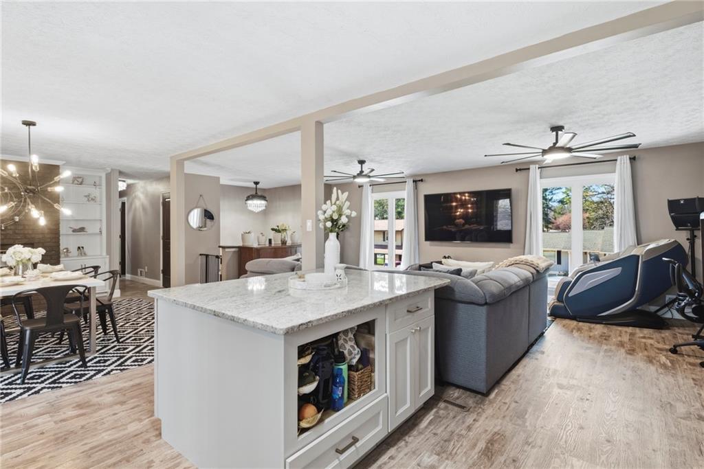 2470 Northbrook Road Snellville, GA 30039 - Photo 11 of 29 a large living room with stainless steel appliances granite countertop couches a flat screen tv and a stove