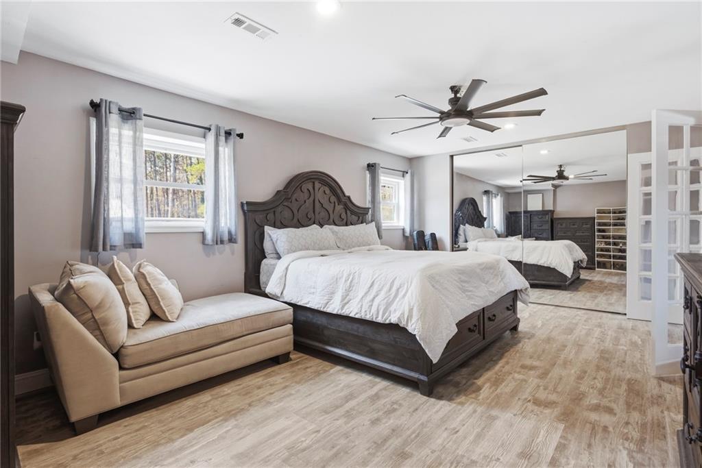 2470 Northbrook Road Snellville, GA 30039 - Photo 12 of 29 a spacious bedroom with a bed couch and window