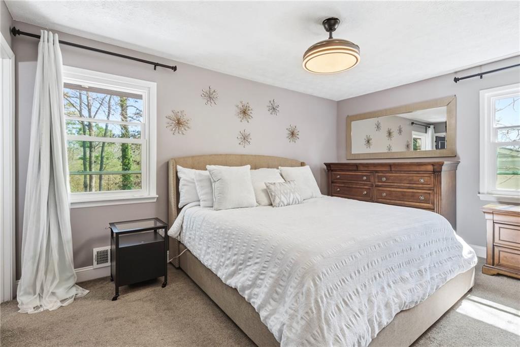 2470 Northbrook Road Snellville, GA 30039 - Photo 17 of 29 a bedroom with a bed and a painting on the wall