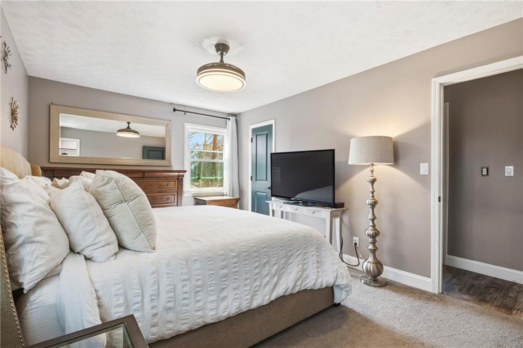 2470 Northbrook Road Snellville, GA 30039 - Photo 18 of 29 a bedroom with a bed and a flat screen tv