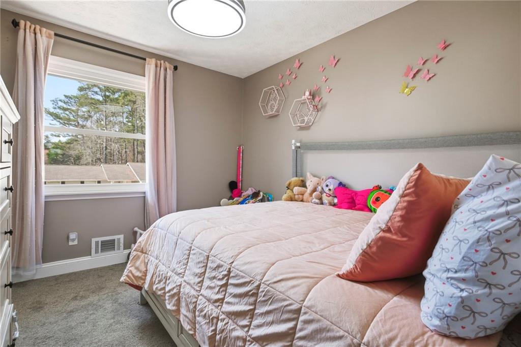 2470 Northbrook Road Snellville, GA 30039 - Photo 22 of 29 a bedroom with a bed and a window