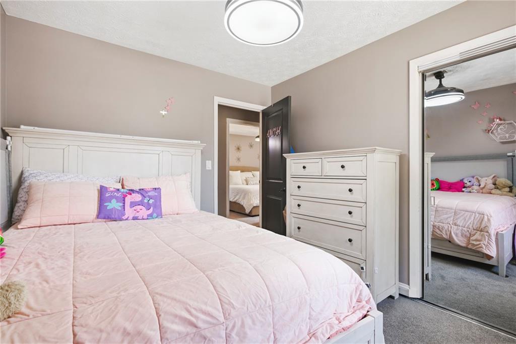 2470 Northbrook Road Snellville, GA 30039 - Photo 23 of 29 a bedroom with a bed and a bathroom