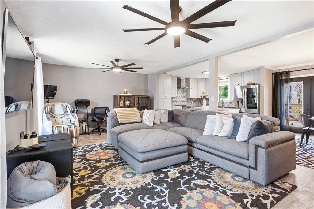 2470 Northbrook Road Snellville, GA 30039 - Photo 6 of 29 a living room with furniture ceiling fan and a rug